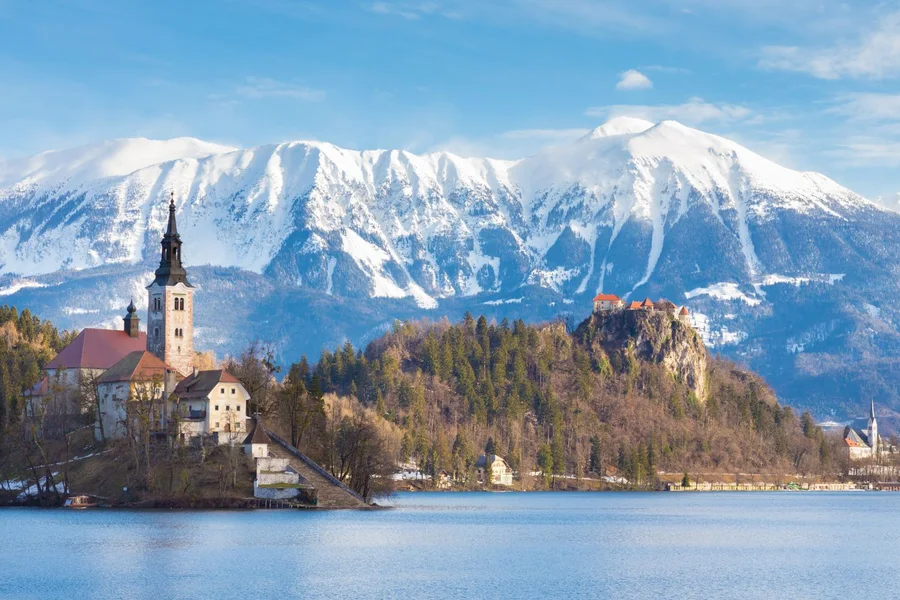 Lake Bled and its castle below the snow-capped Julian Alps