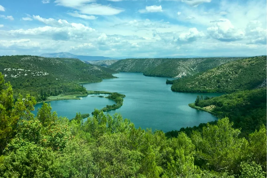 The Krka river winding through its green canyon