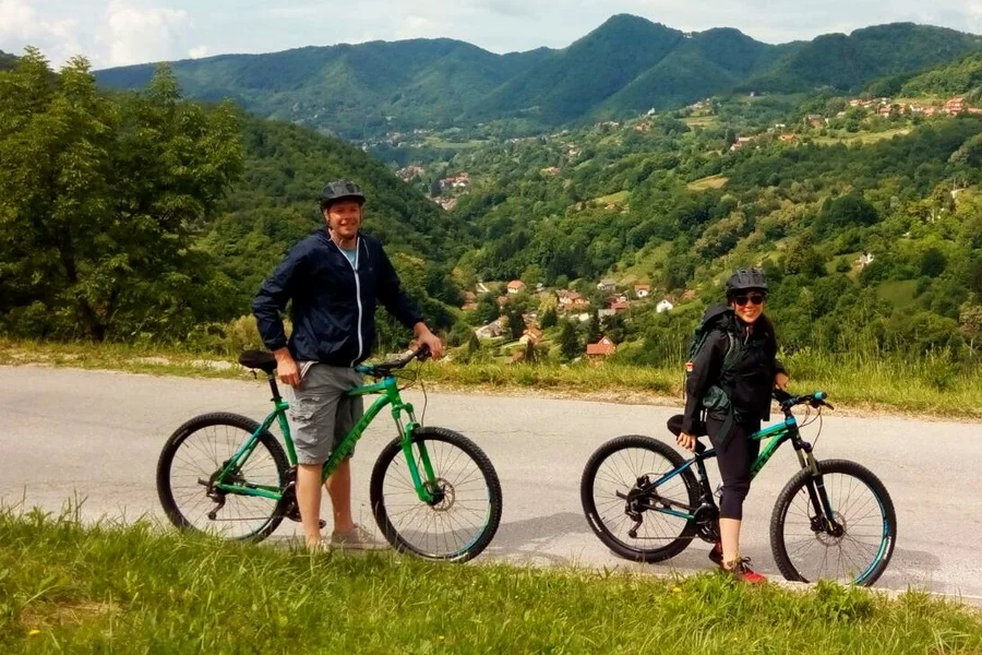 Cyclists on the Plesivica Wine Road with the hills of Zagorje behind