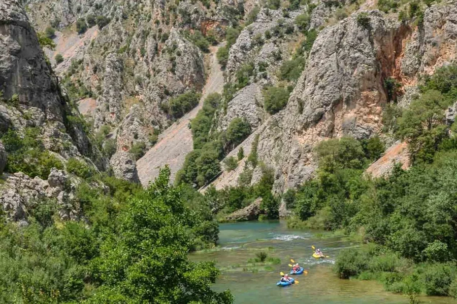 Kayaks on the Zrmanja river seen from high on the canyon rim
