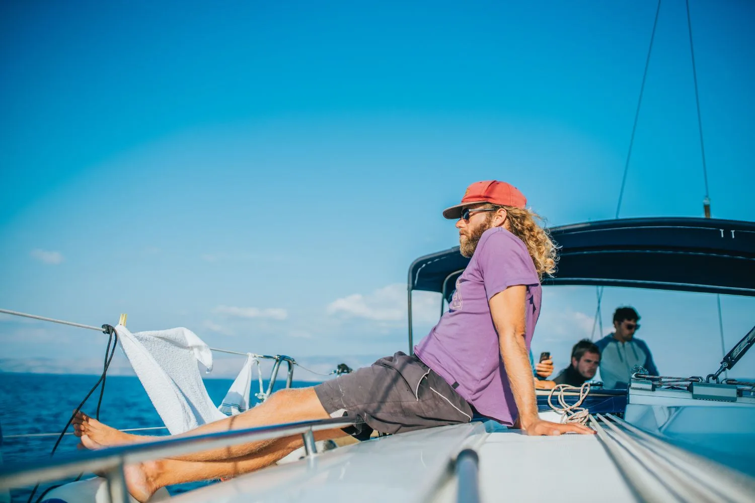 Guests relaxing on the catamaran deck during the sailing trip
