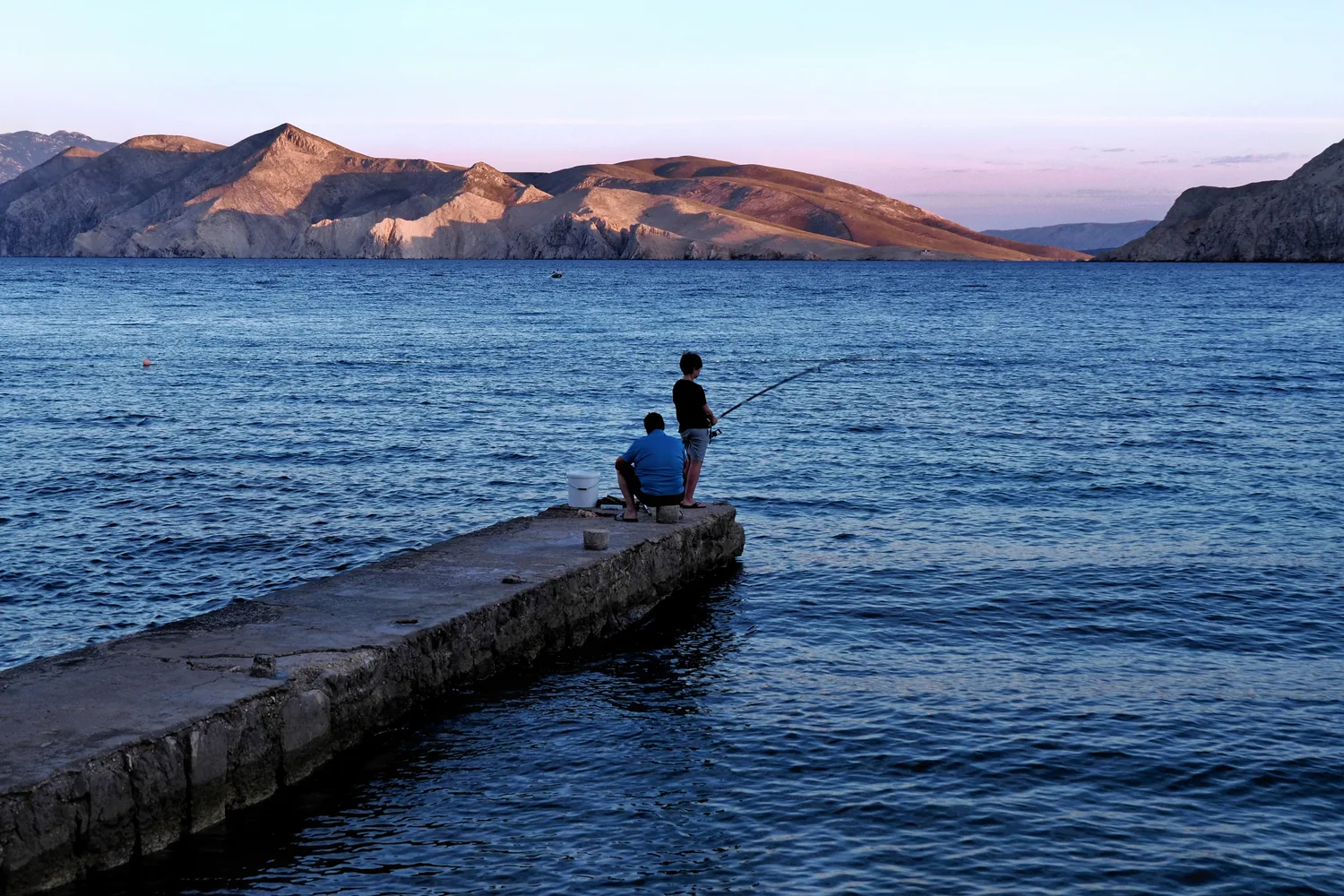 Fishing from a pier at sunset, Krk Island