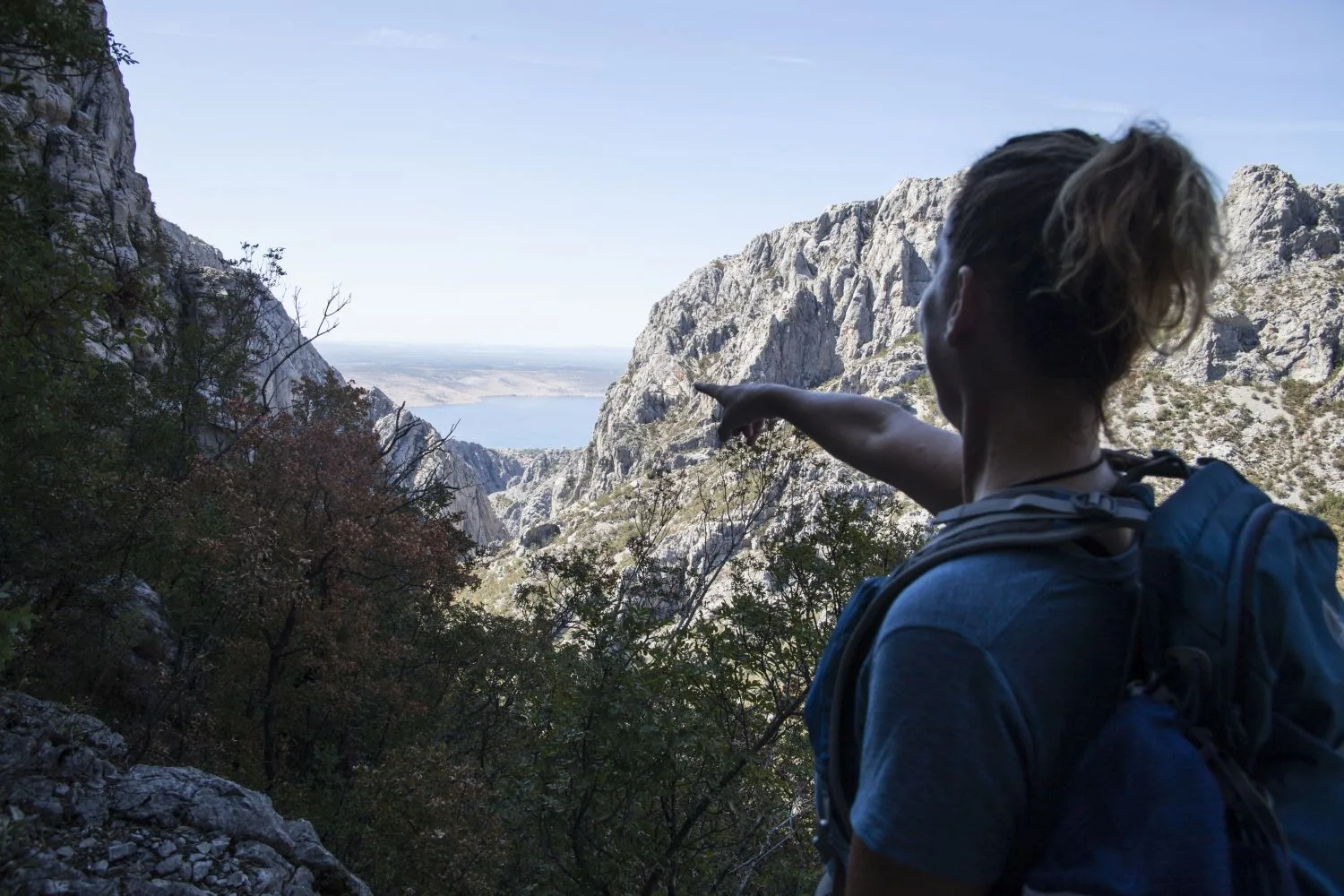 Hiker looking out over the Paklenica canyon towards the sea