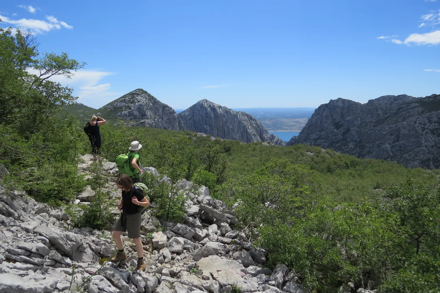 Hikers descending a ridge trail above Paklenica National Park